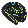 Wollhuhn Öko Long Beanie/Wendemütze, zweilagig, schwarz mit gelben und grünen Schriftzügen, aus weichem Baumwolljersey, ideal für Kinder, ganzjährig tragbar.