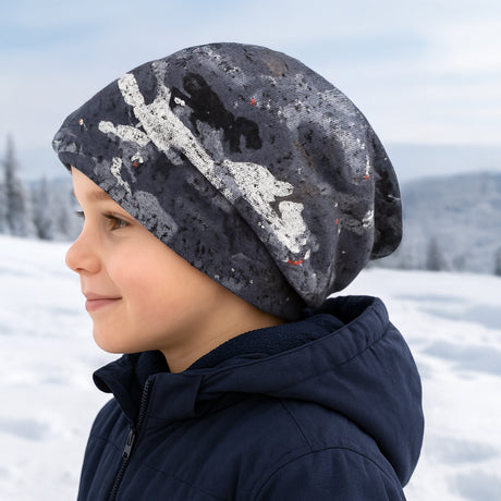 Kind trägt Wollhuhn Öko Long Beanie im Schnee, zweilagig und wendbar, ideal für Winter, hält Ohren warm, bequem und formbeständig, geeignet für Kinder.