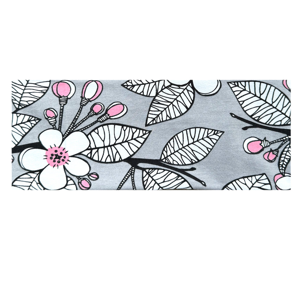 Nahaufnahme eines Wollhuhn elastischen Öko Stirnbands aus Jersey, zweilagig und breit, mit floralem Muster in Grau und Rosa, ideal für vielseitigen Gebrauch.