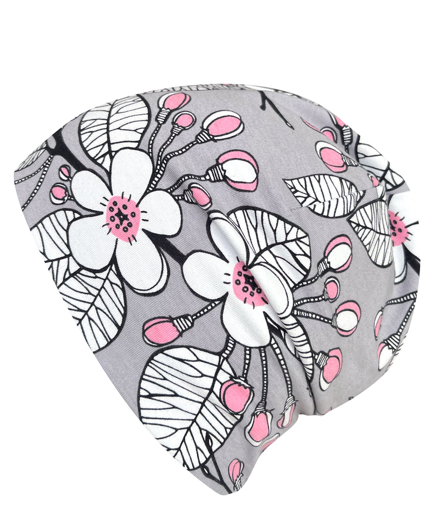 Wollhuhn Öko Shorties: Graue Wendemütze mit rosa-weißen Blumen, handgefertigt aus Öko-Jersey, ideal für aktive Kinder, dehnbar und wärmend.