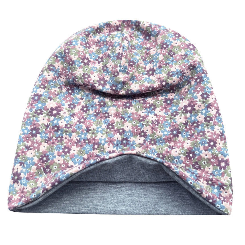 Wollhuhn Öko Long Beanie: Wendemütze aus weichem Baumwolljersey, zweilagig mit Blümchenmuster in Pastelltönen, innen grau. Ideal für Kinder, ganzjährig tragbar.