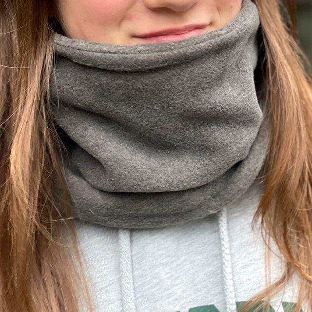 Frau trägt Wollhuhn WINTER Halstuch/Schlupfschal „Unser Wärmster“, doppellagig aus Fleece, ideal für Kälte, handgefertigt in Deutschland, einfach über den Kopf zu ziehen.