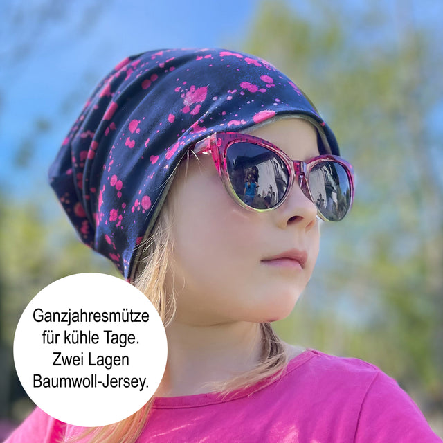 Mädchen trägt Wollhuhn Öko Long Beanie, Wendemütze, zweilagig. Perfekt für ganzjährige Nutzung, bietet Komfort und Stil. Ideal für Kinder, handgefertigt in Deutschland.