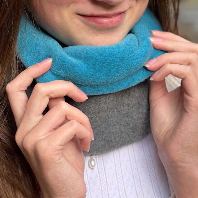 Frau trägt den Wollhuhn WINTER Halstuch/Schlupfschal „Unser Wärmster“, zwei Lagen Fleece, ideal für Kälte, handgemacht, bequem über den Kopf ziehbar.